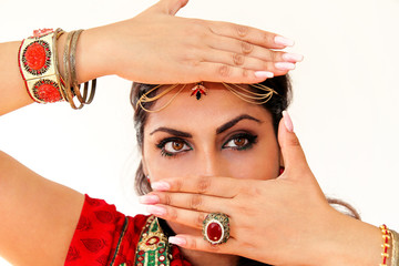 Woman dancing Indian dance in national dress. A handsome beautiful girl portrait in red Hindu...