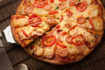 Delicious fresh pizza served on wooden table
