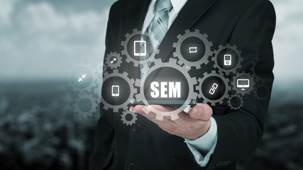 Search engine marketing - SEM concept. Businessman or programmer is focused to improve SEM and web traffic.
