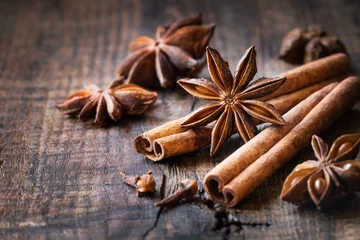 Fotobehang Traditional Christmas spices - star anise, cinnamon sticks and cloves for festive baking © kuvona