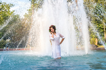 beautiful sexy girl bathing in city fountain, in summer