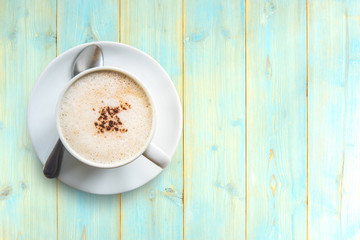 Top view hot Latte Coffee in cup on Wooden table textured background.