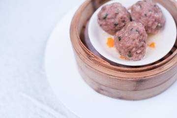 Meat balls with tomato sauce and wooden spoon, close-up