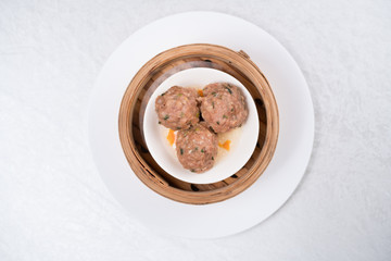 Fototapeta na wymiar Meat balls with tomato sauce and wooden spoon, close-up