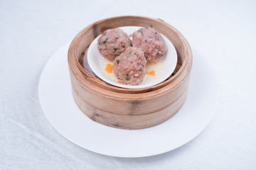Meat balls with tomato sauce and wooden spoon, close-up