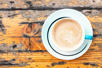 Latte cup on wooden table with place for text