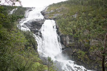Fototapeta premium Waterfall in mountains of Norway in rainy weather.