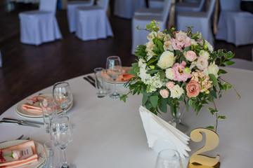 The numbering of the tables. Flowers in the restaurant, table setting