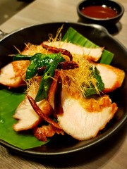 Charcoal boiled pork neck, Thai Northeast food, hot on plate, smells delicious herb