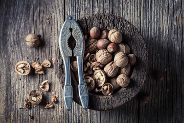 Fresh walnuts and hazelnuts with on rustic wooden table