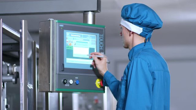 Touch screen technology. Close up of factory worker program touch screen control. Factory employee control screen. Industrial factory control display. Industrial control screen
