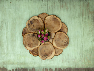 Wooden background with little pink roses. Grunge mockup. Green old painted texture.