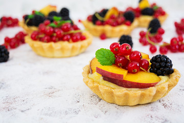 Tartlets with different berries on white background
