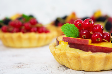 Tartlets with different berries on white background