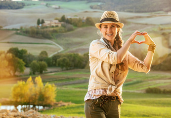 woman hiker in Tuscany showing heart shaped hands