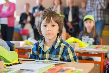 Obraz na płótnie Canvas Young first grade student sitting at desk on his first day at school