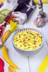 Homemade corn cream soup with thyme and pepper chili on a white background