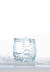 cool water, Ice cubes splashing into glass of water, water splashing from ice cubes being dropped in a glass.