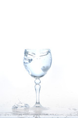 cool water, Ice cubes splashing into glass of water, water splashing from ice cubes being dropped in a glass.
