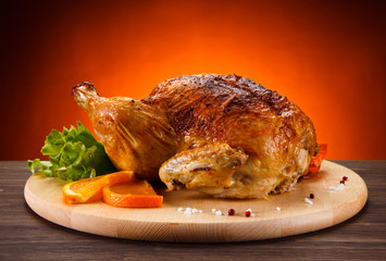 Roast chicken on cutting board 