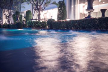 abstract blur and defocused swimming pool in sport club at  night, long exposure photography for water movement