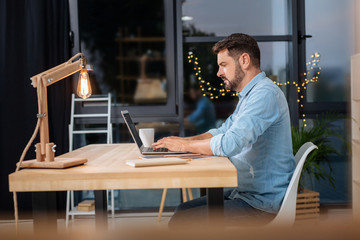 Smart self employed businessman working on his laptop