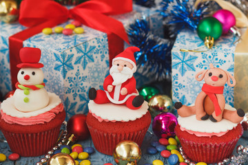 Christmas cupcakes with colored decorations made from confectionery mastic