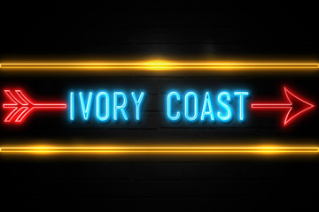 Fototapeta premium Ivory Coast - fluorescent Neon Sign on brickwall Front view