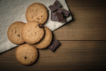 Crunchy malt cookies on dark old wooden table