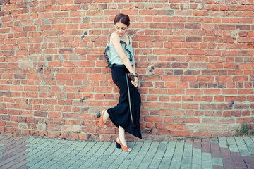 Woman near the red old wall
