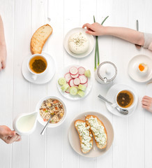 Family eating breakfast , toasts with cottage cheese, topview