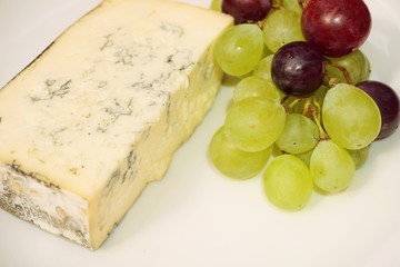 Red grapes with cheese  on white background.