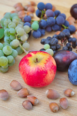 Assorted autumn fruit on the wooden table