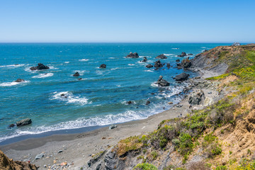 Fototapeta na wymiar Incredible landscape of the coast. Beautiful blue sea. The waves rolled ashore and breaking on the rocks. Sonoma Coast State Park, California, USA