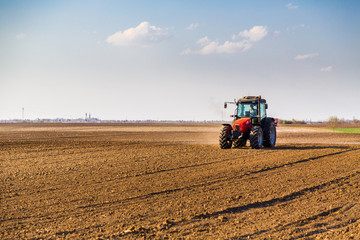 Farmer fertilizing arable land with nitrogen, phosphorus, potassium fertilizer