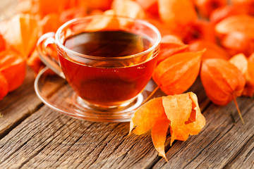 cup with hot drink on a wooden background autumn