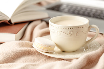 Still life with cup of coffee and book on wooden table, on white background