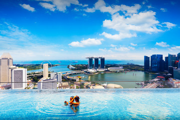 Swimming pool on roof top with beautiful city view, Singapore - obrazy, fototapety, plakaty