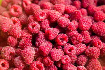 Fresh raspberries background closeup top view