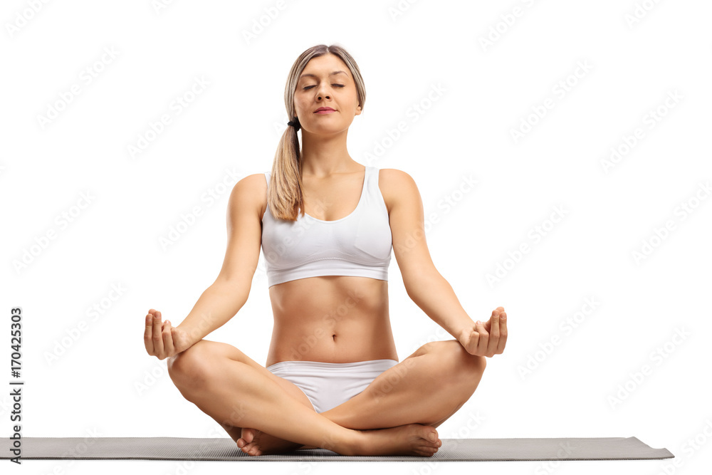 Poster Young woman meditating on an exercise mat