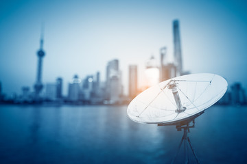 In the city night background large satellite antenna