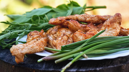 Chicken grilled with herbs on a wooden stand. Selective focus.