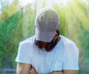 guy in a baseball cap and headphones