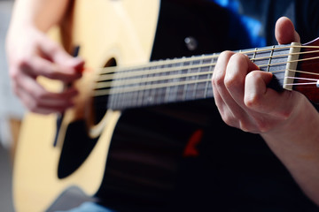 Fototapeta na wymiar man's hands playing acoustic guitar