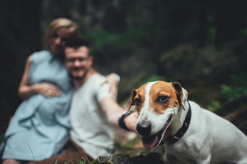 Romantic happy couple in love enjoying their time with pets in nature