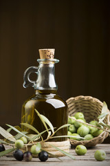 Olive oil and olives on wooden rustic table