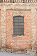 Old brick house with window protected with gratings 