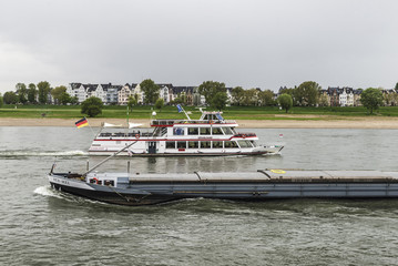 Merchant ship and cruise ship sailing on the Rhine River