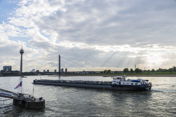 Merchant ship sailing on the Rhine River at dusk in Germany