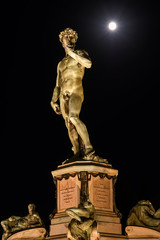 Under a Giant spotlight, Piazzale Michelangelo, Florence, Tuscany, Italy, Europe Statue of David by Michelangelo the evening of the 7th August 2017 with the Full Moon.